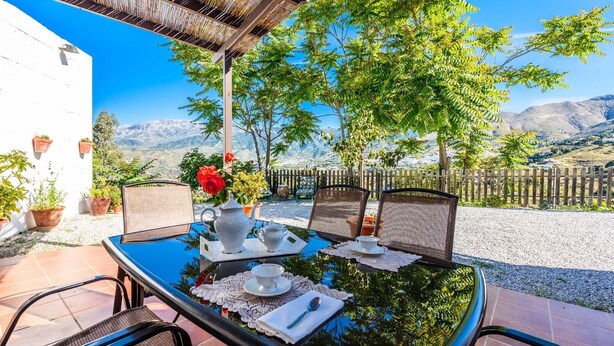 A table set for two with a view of mountains in the background. - Mirador de Cómpeta by Ruralidays (Málaga)