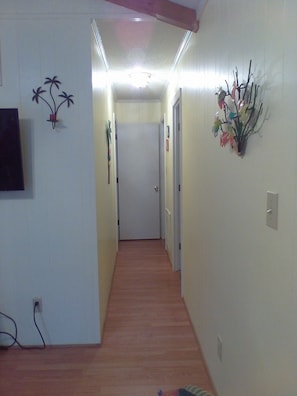 Stylish hallway with a floral touch, featuring a door leading to a space.