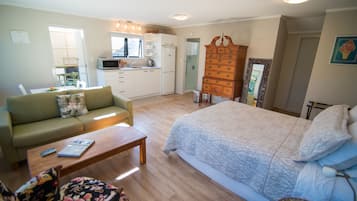 Deluxe Studio Suite, Garden View | Desk, blackout drapes, iron/ironing board, free WiFi