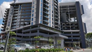 A multi-story building with a modern architectural design, featuring balconies and a parking structure. - 118 Residence (Bandar Seri Begawan)