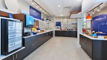 A modern breakfast area with a self-serve station for yogurt, eggs, and milk.