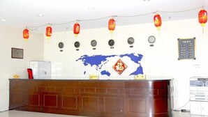 A reception desk with a world map, clocks, and traditional red lanterns. - Yabuli Olympic Club Hotel (Harbin)