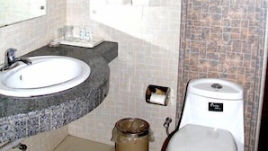A bathroom with a white sink, a toilet, and a mirror. - Yabuli Olympic Club Hotel (Harbin)