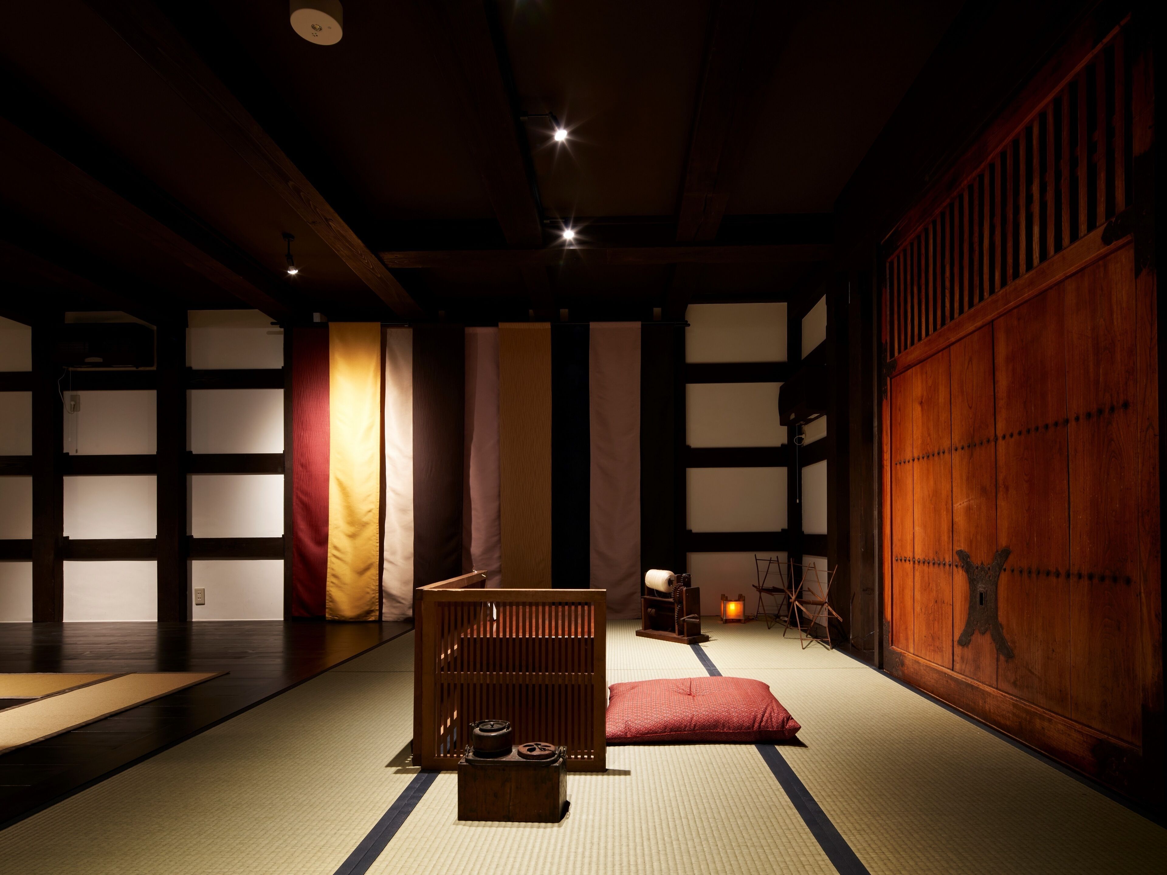 A traditional Japanese room with tatami flooring, a low wooden table, and a shoji screen.