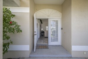 Enter a welcoming space with a clean design, featuring a white door and a decorative arch.