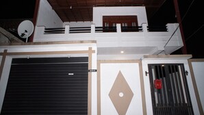 A building with a garage door, a satellite dish, and a security gate. - Villa304 (Galle)