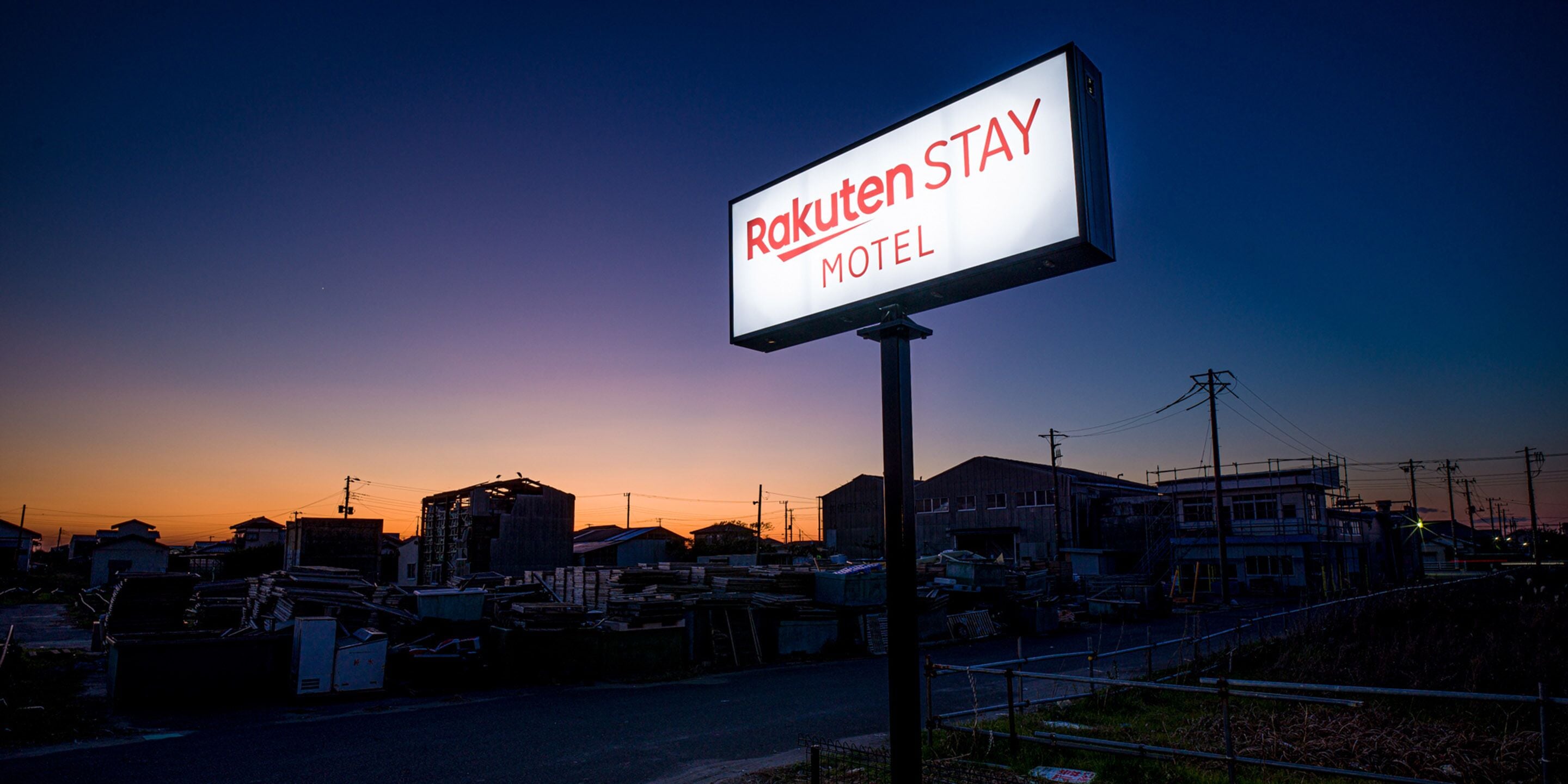 A sign for the Rakuten Stay Motel.