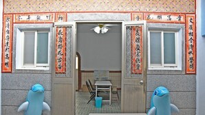 A room with a desk, chairs, and a blue inflatable whale decoration. - Tumbler Travel (Jinning)