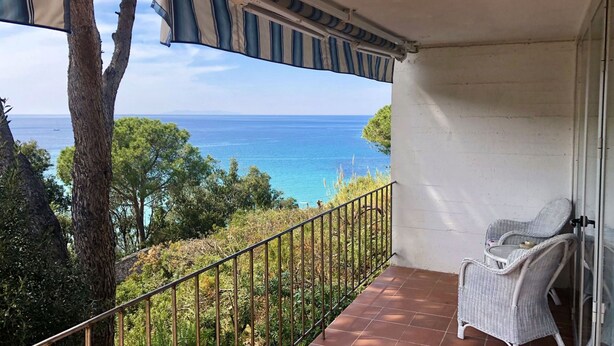 A balcony with a view of the sea, a wicker chair, and a railing. - Scaglieri Mare - ibookingelba.com (Portoferraio)