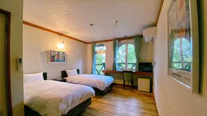 A room with two beds, a desk, and a window with curtains. - Lodge Atelier (Hokuto)