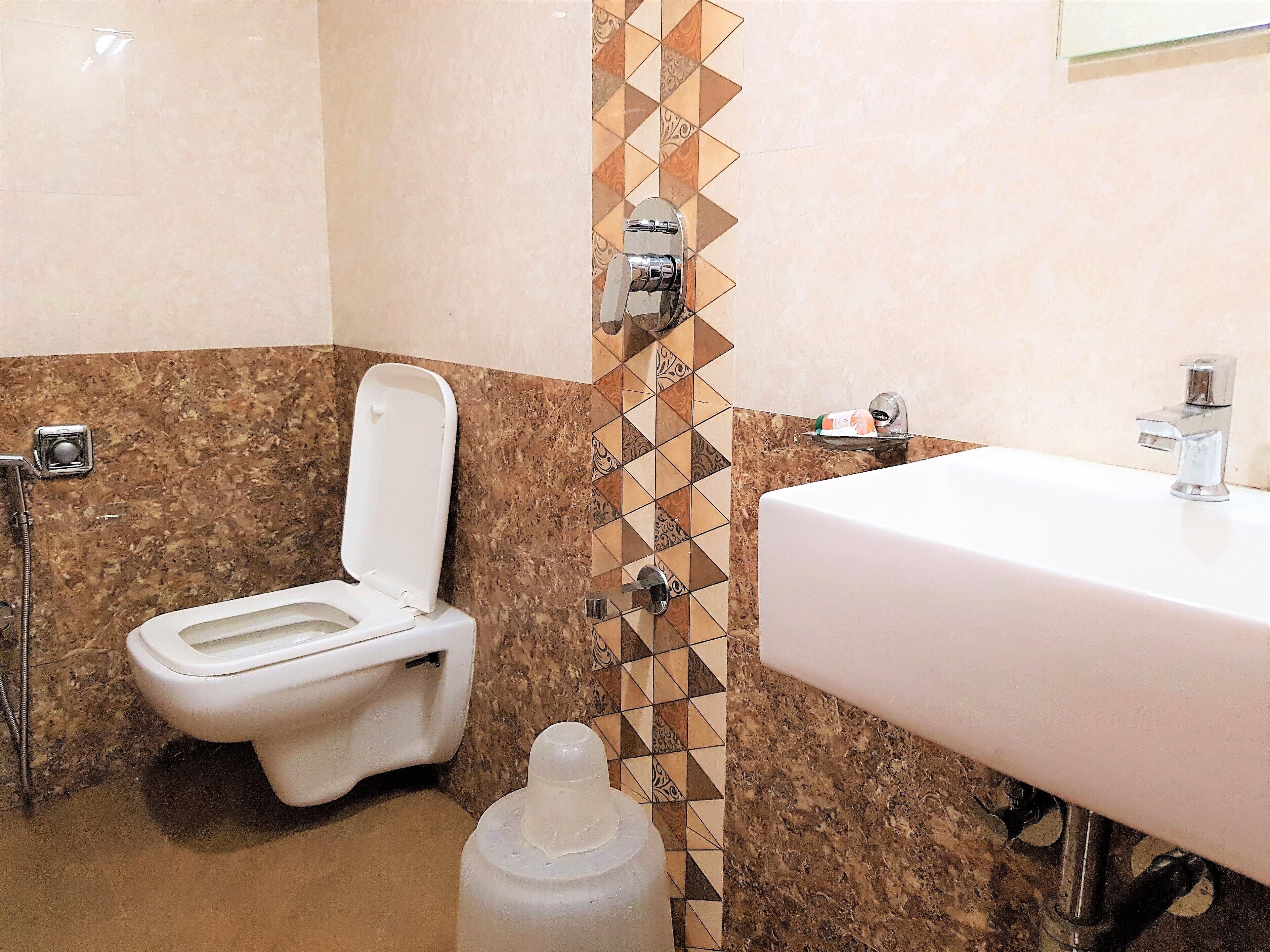A bathroom with a toilet, a sink, and a shower.