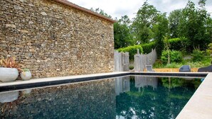 A stone wall, a swimming pool, and a wooden fence. - Dreamy Retreat in Loubejac (Loubejac)