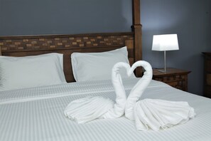 A neatly made bed with white pillows and a heart-shaped towel arrangement. - Hotel Ali Imran (Bandar Baru Bangi)