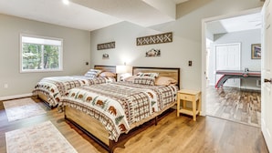 A bedroom with two beds, a wooden floor, a window, and a door leading to another room. - Home < 2 Mi to Mtn Greens Golf, Massanutten Ski! (Mcgaheysville)