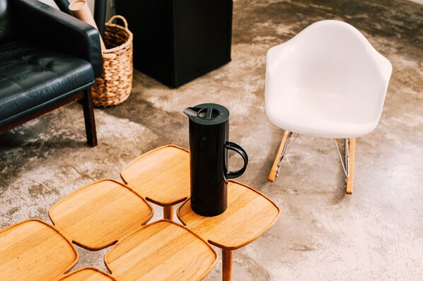 Eine schwarze Kaffeetasse auf einem Holztisch mit einem besonderen geometrischen Muster.