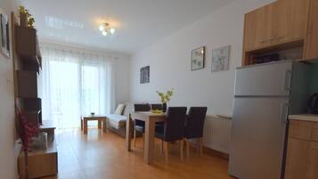 Apartment, Sea View | Living room | Flat-screen TV