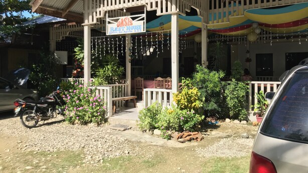 A building with a sign reading "Oasis Rest House."