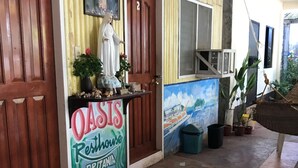 A building entrance with a sign for 'OASIS Resthouse BRITANIA'. - Oasis Resthouse (San Agustin)