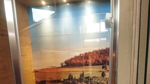 A modern elevator with a panoramic mural of a countryside landscape. - Michele Guest House (Pisa)
