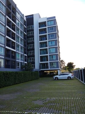 Stylish residential building with a symmetrical facade and balconies on each floor.