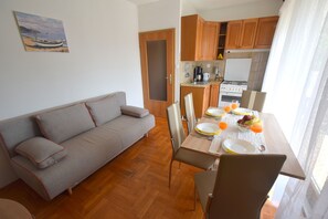 Apartment, 2 Bedrooms | Living room | Flat-screen TV