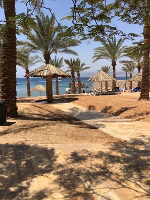 On the beach, sun loungers, beach towels - Beachfront Apartment with Fantastic Red Sea View, Close to Downtown (Aqaba)