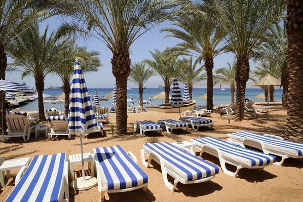 On the beach, sun-loungers, beach towels