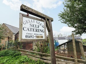 A wooden signboard for Gelli Club Self Catering with contact details. - Gelli Glud (Colwyn Bay)
