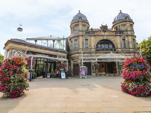 A historic building with the sign "Opera House" and entrances labeled "Upper Circle" and "Dress Circle and Stalls". - The Haven (Buxton)