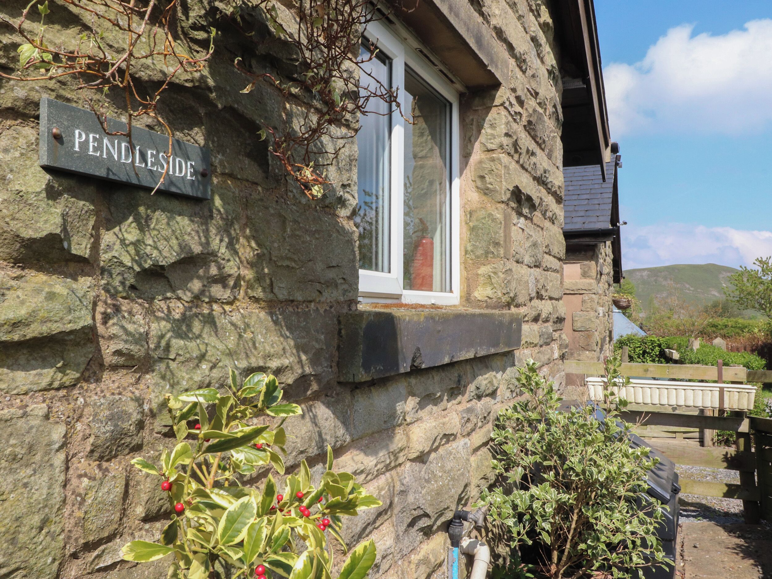 A stone building with a sign reading "PENDLESIDE".