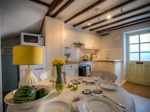 Enjoy meals in this kitchen with an oven, microwave, and dining table.