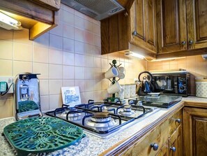 Enjoy cooking in this well-equipped kitchen with a gas stove, microwave, and kettle.
