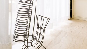 A metal floor lamp with a curved base and a tall, slender stand. - Beating Heart City Family Home Next to Beach (Chania)