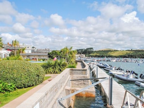 Stroll along the marina, surrounded by boats and a beautifully maintained garden.
