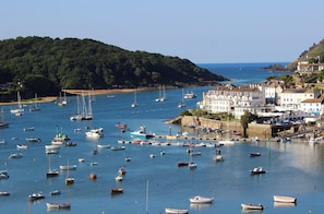 Experience the tranquil atmosphere of this coastal town, surrounded by a bustling harbor and lush greenery.