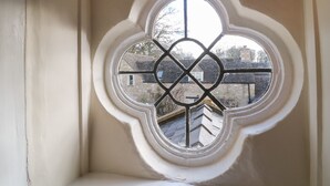 A window with a white frame and a geometric pattern. - South Hill Farmhouse (Cheltenham)