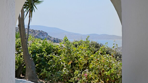 An outdoor patio with a clear view of a mountainous landscape. - Ailouros summer hotel (Naxos)