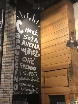A chalkboard menu with various coffee and food items listed, such as 'Caffe Freddo' and 'Lime & Menta'. - Old Bakery Guest house (Rome)