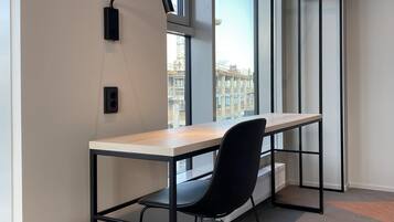 A modern office space with a desk, chair, and bench.