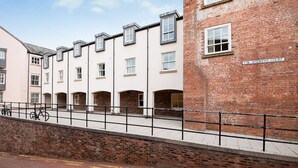A row of terraced houses with a brick building labeled "St. Andrews Court" to the right. - St Andrews Court (Durham)