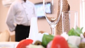 A dining table with a salad, a glass of water, and a napkin. - Kelin Court Hotel (Lagos)