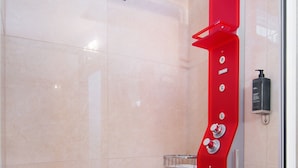 A modern shower with a red control panel and a glass door. - Ali Pasha Hotel (Ioannina)