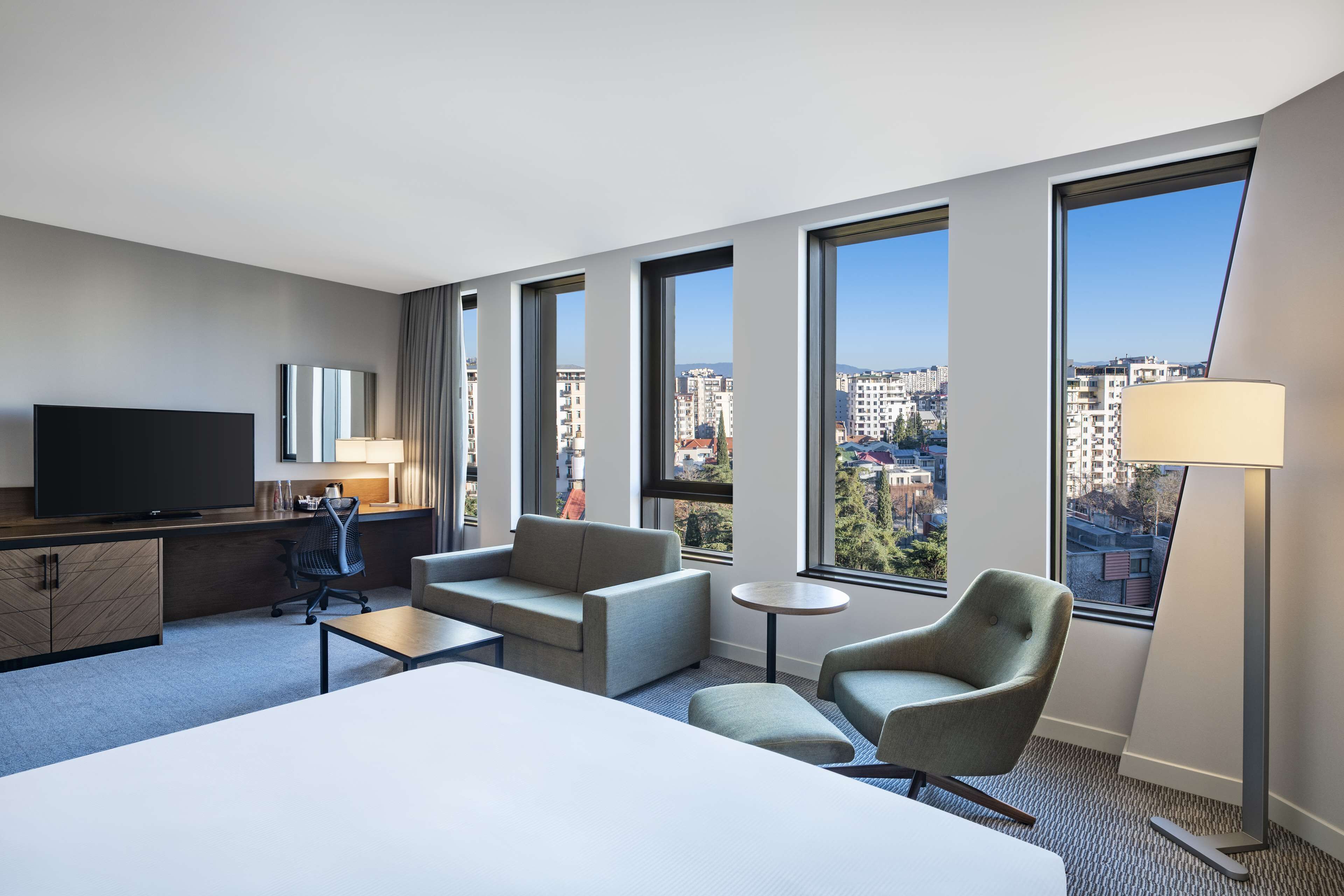 Junior Suite, 1 King Bed | Living area | 55-inch LCD TV with satellite channels, TV