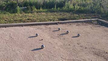 A rooftop with several spherical objects scattered across a gravel surface.