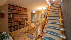 A staircase with wooden steps and a railing, leading to an upper floor. - Zającówka (Szklarska Poreba)