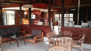 A cozy indoor seating area with wooden furniture and a television.