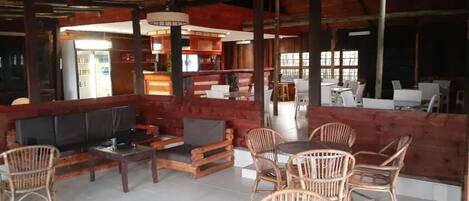 A cozy indoor seating area with wooden furniture and a television.