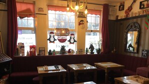 A cozy restaurant with a red interior, wooden tables, and a Christmas theme. - Don Valley Hotel (Sheffield)