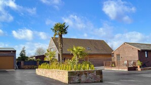 A building with a sloped roof and a brick facade. - Baytree Lodge - UK13322 (Melbourne, near Derby)