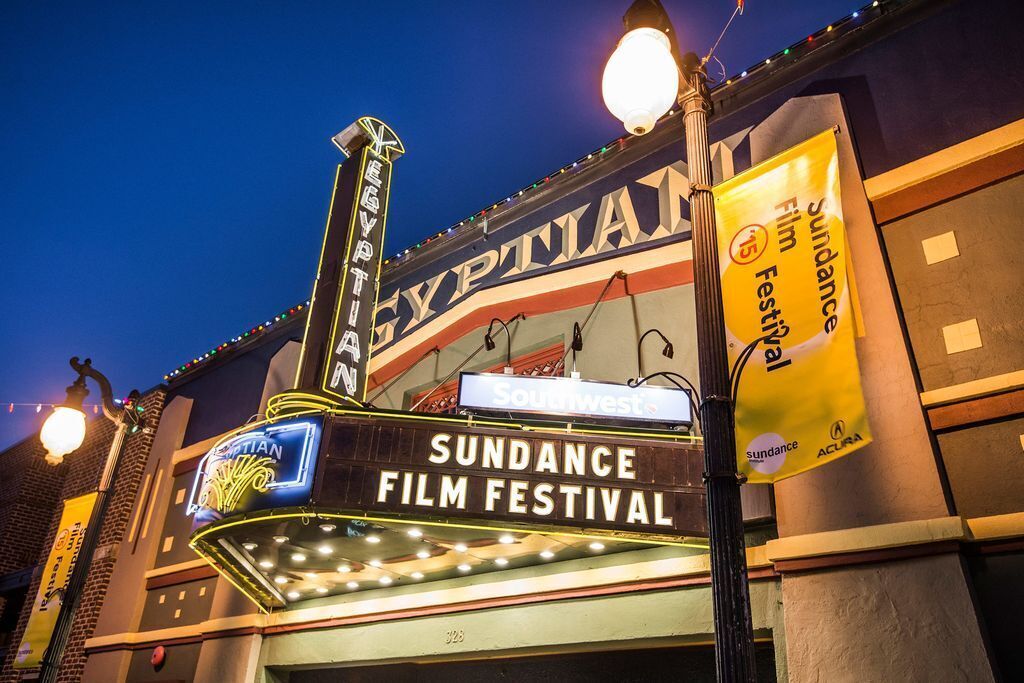 A theater marquee with "SUNDANCE FILM FESTIVAL" and "ACURA" branding.